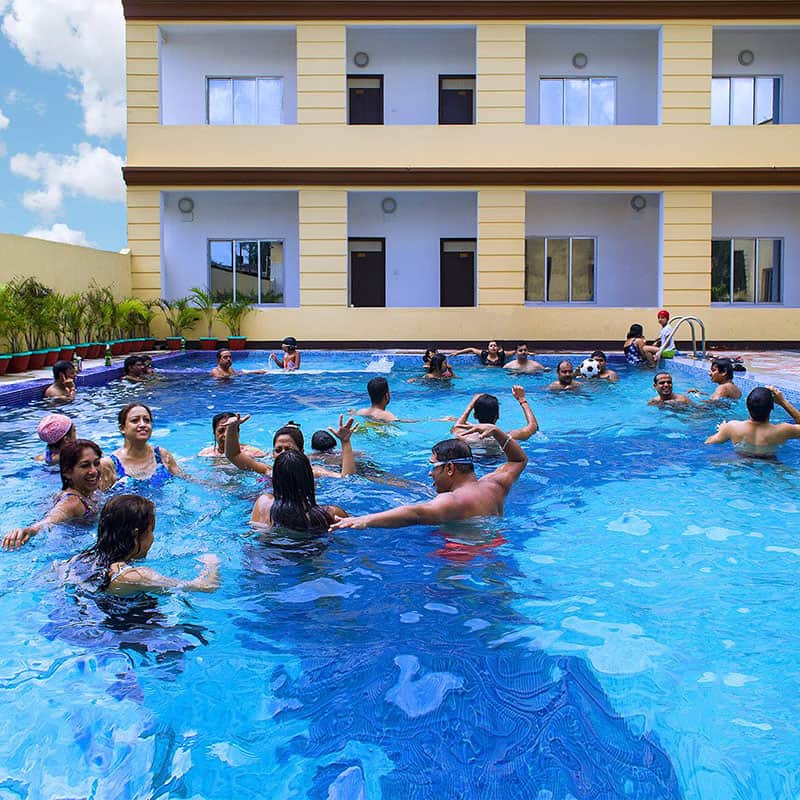 Guests enjoying at the Swimming pool in Anutri Beach Resort